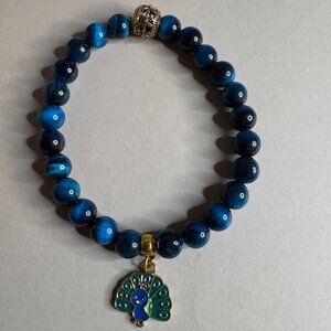 elegant bracelet with a decorative gold-rimmed enamel charm